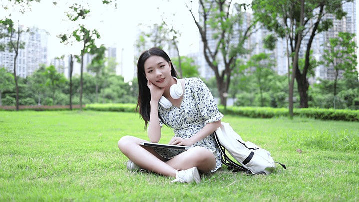 pngtree-young-college-student-sitting-on-the-grass-thinking-girl-girl-woman-image_791850